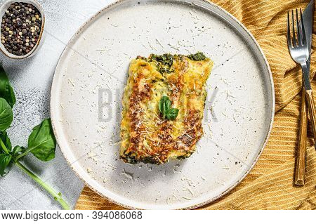 Cannelloni With Ricotta And Spinach. Italian Cuisine. Gray Background. Top View