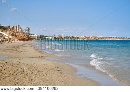 Breaking Waves Of Mediterranean Sea In The Mil Palmeras Sandy Empty Beach. Province Of Alicante, Cos