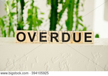 Overdue Invoices Concept. Word Overdue Written On Wooden Cubes