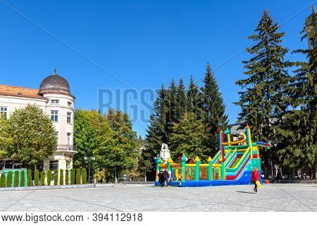 Razlog, Bulgaria - October 20, 2020: Downtown Street Square Panoramic View With Autumn Trees And Peo