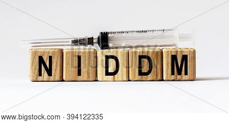 Text Niddm Made From Wooden Cubes. White Background