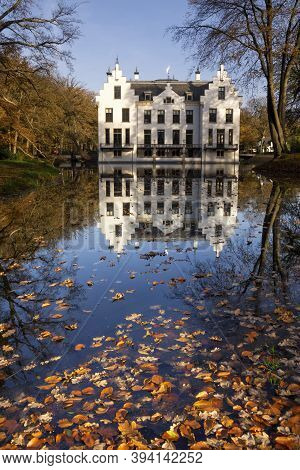 Castle Staverden On The Dutch Nature Area Veluwe Reflecting In The Moat And Surrounded By Autumn Col