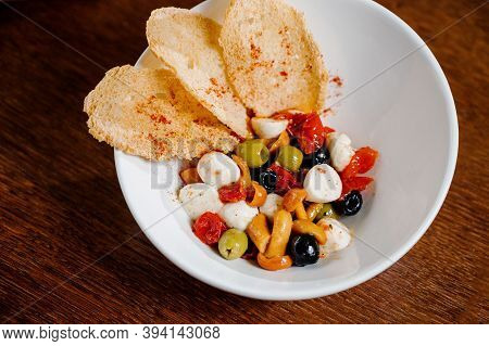 Appetizer With Pickled Mushrooms, Olives, Parmesan On Wooden Background