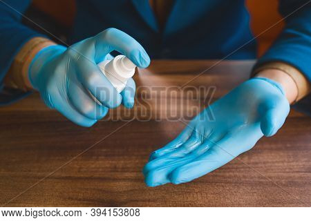 Businessman Hands In Protective Medical Gloves Hold And Spray Antiseptic