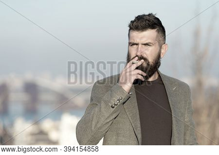 Nicotine Abuse. Cigarette Smoker. Bearded Man Smoke Nicotine Cigarette Outdoor. Addiction To Nicotin