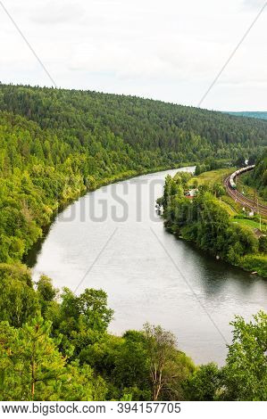 Kungur, Perm Region, Russia - August, 8 2020: Long Multicolored Freight Train Goes Along Chusovaya R