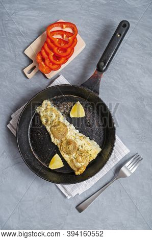 Fried Baked Mackerel Trachurus With Onions And Dried Herbs In An Old Frying Pan With A Towel And For