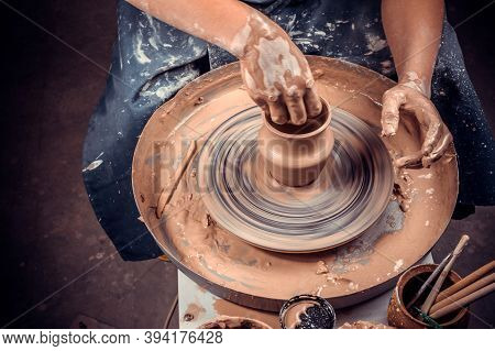 Potter Female Student Creates A New Pottery From Clay On A Potters Wheel. Handmade. Close-up.