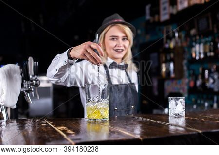 Girl Barman Makes A Cocktail At The Taproom