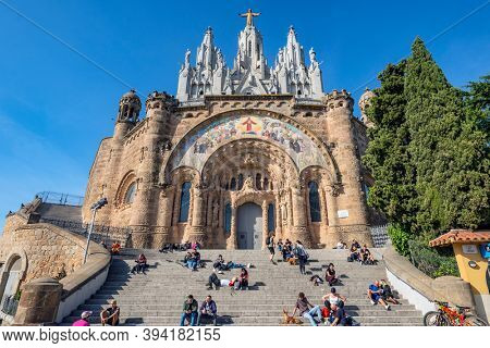 BARCELONA, SPAIN - NOV 07 -2020: People relaxing in front of Tibidabo church on mountain in Barcelona 