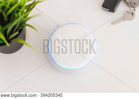 Amazon echo dot , Alexa voice controlled speaker with activated voice recognition, on brick and white background