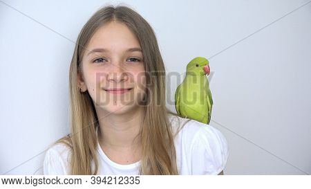 Girl Talk Parrot, Happy Kid Playing Her Pet, Child Plays Bird At Home, Funny Indian Ring-necked Para