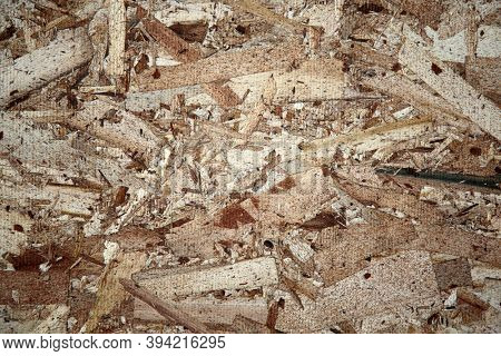 Chipboard. A sheet of Chipboard plywood with wood grain. Chipboard is used world wide in many construction projects. Made from scraps of wood it is compressed and glued into sheets for construction. 