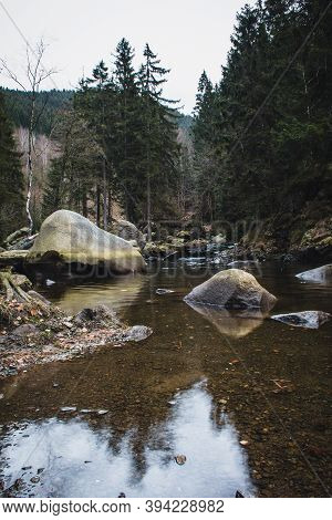 River Oker Flowing Through The Valley Okertal. Wild Scenery Near The Famous Engagement Island (verlo