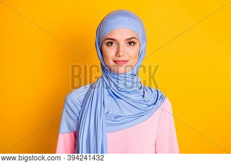 Close-up Portrait Of Attractive Cheery Modest Muslimah Wearing Blue Hijab Isolated Over Bright Yello
