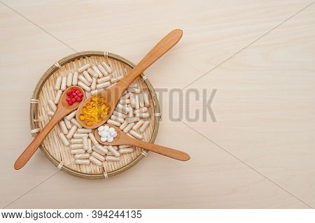 Healthy Lifestyle - Vitamins, Minerals And Nutritional Supplements In Wooden Spoons Inside A Braided