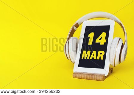 March 14th. Day 14 Of Month, Calendar Date. Stylish Headphones And Modern Tablet On Yellow Backgroun