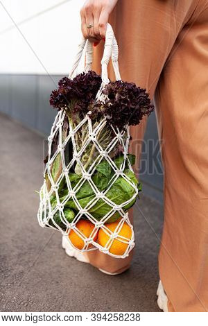 Girl Is Holding Mesh Shopping Bag With Vegetables, Greens Without Plastic Bags. Zero Waste, Plastic 