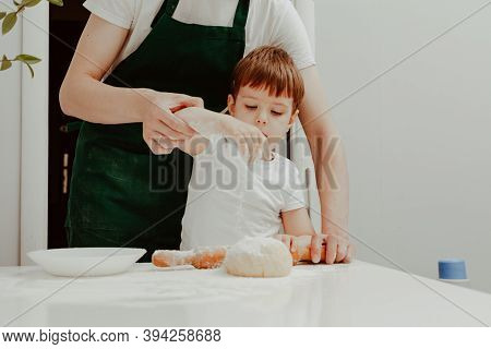 Little Boy Helps Mother To Cook  Making Homemade Coockies. Casual Lifestyle In Home Interior, Pretty