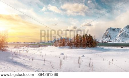 Winter Scenery With Frozen Fjord On Vestvagoy Island At Sunset With Snowy  Mountain Peaks Near Valbe