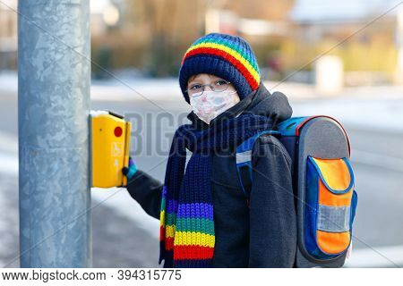 Little Kid Boy With Glasses Wearing Medical Mask On The Way To School. Child Backpack Satchel. Schoo