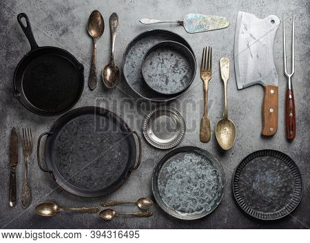 Old Vintage Tableware And Kitchen Utensils On Rustic Stone Background, Top View. Various Metallic Pl