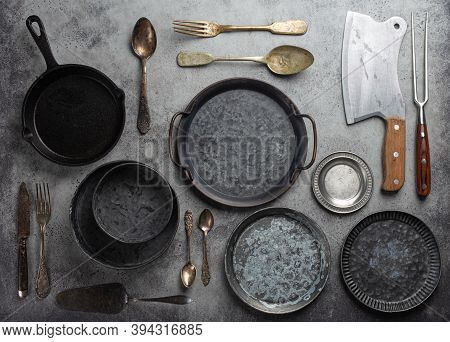Old Vintage Tableware And Kitchen Utensils On Rustic Stone Background, Top View. Various Metallic Pl