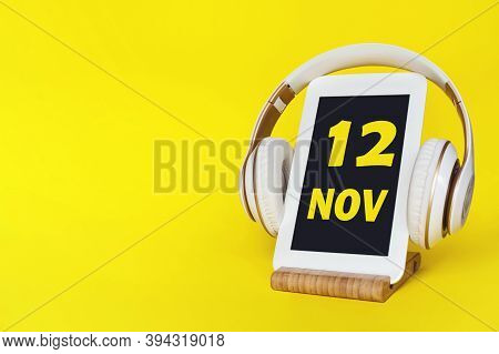 November 12nd. Day 12 Of Month, Calendar Date. Stylish Headphones And Modern Tablet On Yellow Backgr