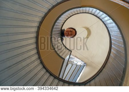 Woman Looking Down On The Top A Spiral Staircase, Circular Architectural Shape, San Diego, Californi