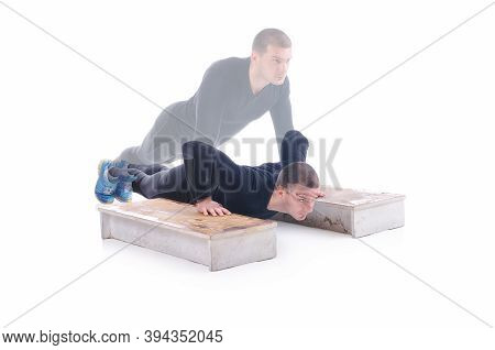 Concentrated Young Sportsman Exercising And Doing Push Ups On The Wooden Stairs. White Background. S
