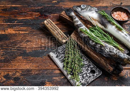 Whole Fresh Raw Icefish On A Wooden Cutting Board. Wooden Background. Top View. Copy Space