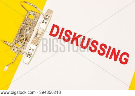 The Word Diskussing On A White Background With A Yellow Folder. Business Concept