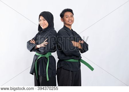 The Two Asian Fighters Wearing Pencak Silat Uniforms With Crossed Hands