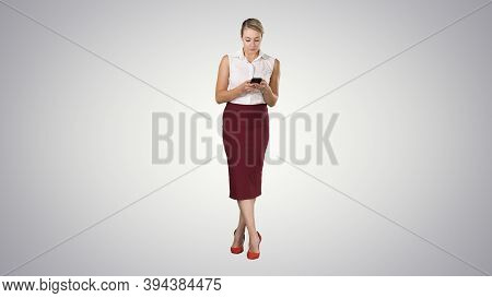 Attractive European Female With Smartphone In Hand, Touching Scr