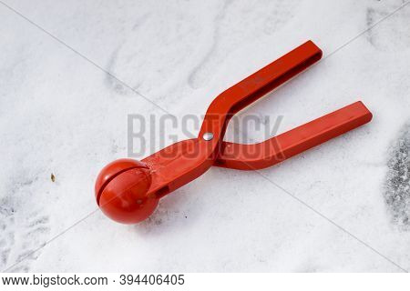 Bright Red Plastic Device, Toy Clip For Making Snowballs On White Snow Background. Happy Childhood A