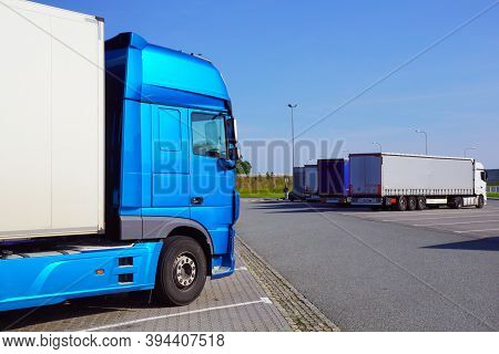 Truck Stop. Various Types And Colors Of Cabins. Trucks Parked In A Row. Break In A Trip.
