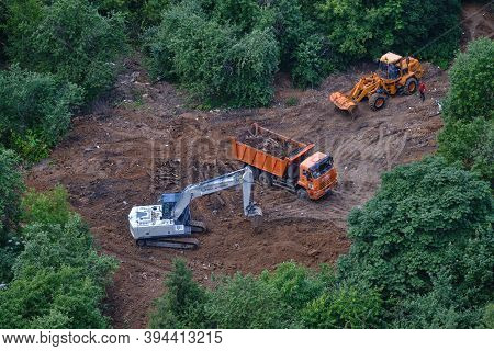 Top View Of A Park With Green Trees In Which Construction Equipment Works - July 10, 2020, Moscow, R
