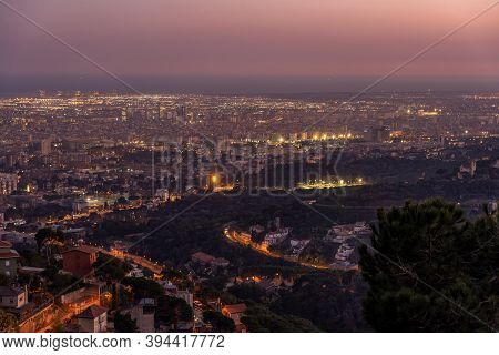 Barcelona City Night View Lights On Top Of Mount Tibidabo At Blue Hour