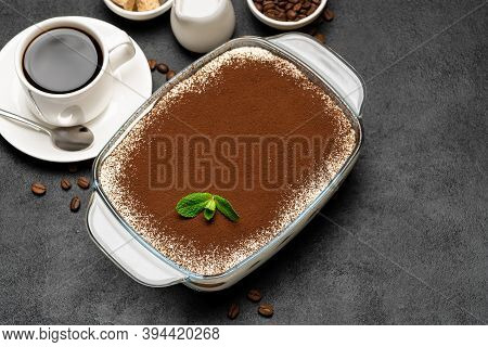Traditional Italian Tiramisu Dessert In Glass Baking Dish And Cup Of Fresh Hot Espresso Coffee On Co