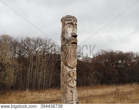Russia, Saratov - Nov, 2020: Wooden Idol Of The Slavic God Perun Near The Path In The Forest. Gloomy