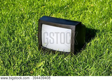 Old Analog Television Set On The Grass Outdoor