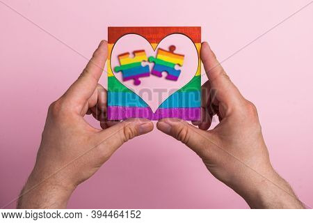 Lgbt Symbol Frame Heart In Male Hands Inside Puzzles Painted By A Rainbow On A Medical Mask. Coronav