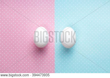 Gener Iquality Concept. Two Eggs On Pink And Blue Background. Top View, Copy Space
