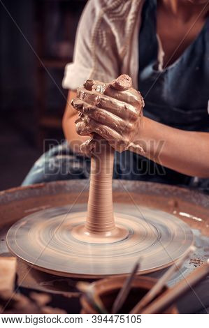 Production Process Of Pottery. Forming A Clay Teapot On A Potters Wheel.