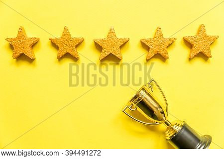 Simply Flat Lay Design Winner Or Champion Gold Trophy Cup And 5 Stars Rating Isolated On Yellow Back