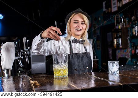 Girl Bartender Concocts A Cocktail At The Saloon