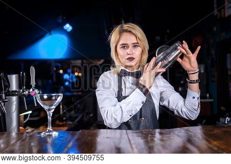 Pretty Woman Bartending Demonstrates His Skills Over The Counter While Standing Near The Bar Counter