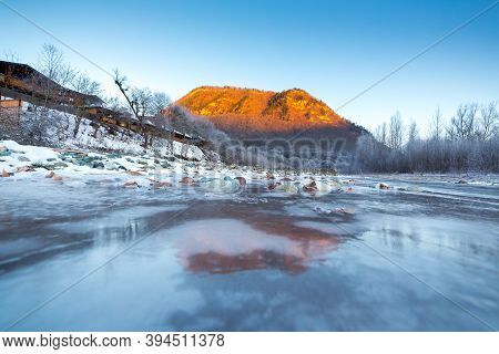 Beautiful Sunny Winter Landscape With Ice River And The Mountain.