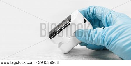 Medical Concept. Pulse Oximeter In Hand. Medical Protective Glove. Pneumonia, Covid Prevention And C