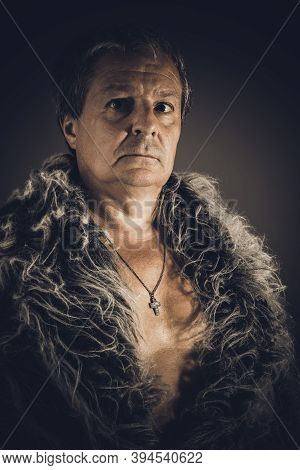 Solid Middle-aged Man In A Fur Mantle
